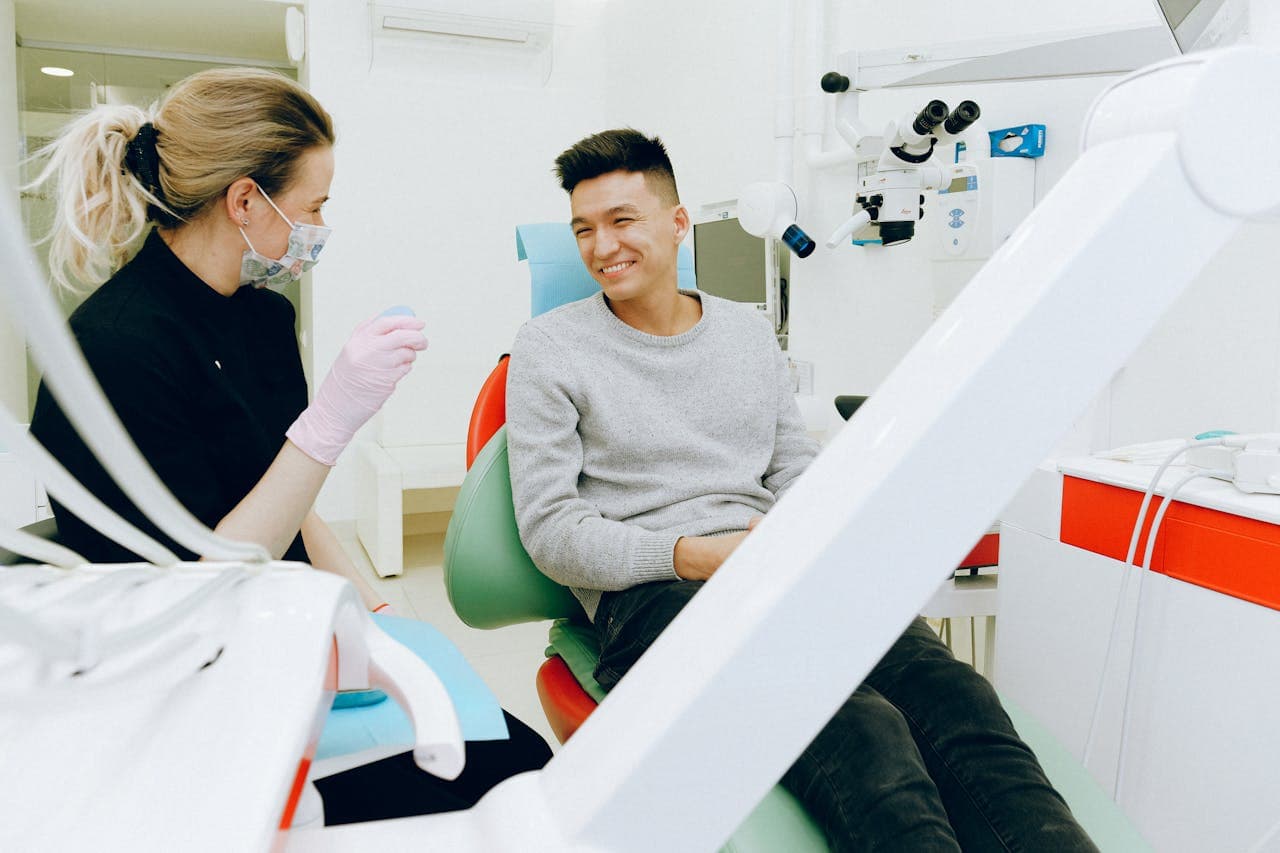 dentist and man patient having his dental checkup