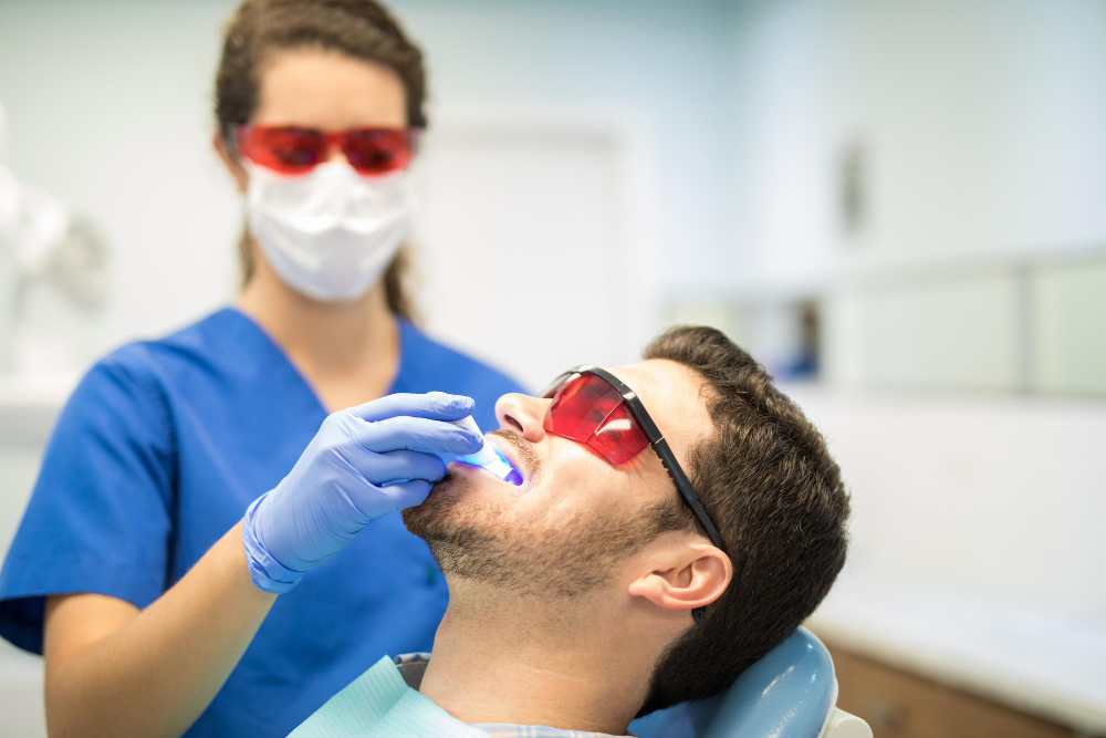 dentist examines patient's teeth