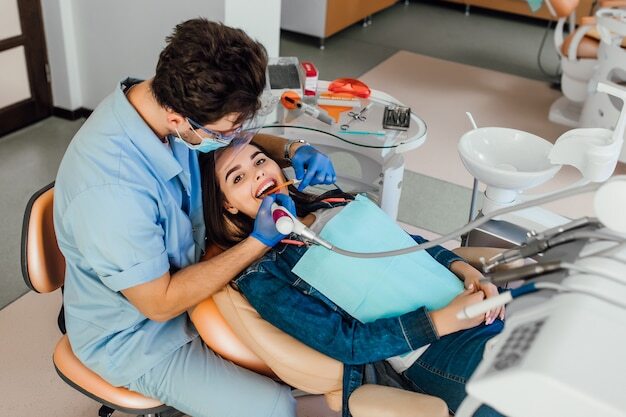 Dentist treating a patient in a clinic