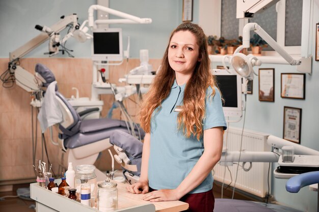 charming female dentist-standing stomatology cabinet