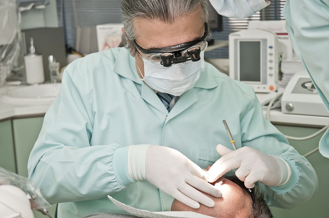 dentist doing dental procedure with his patient