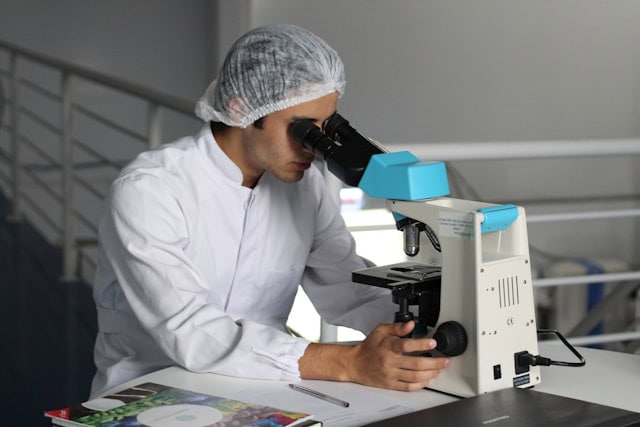 person using a microscope