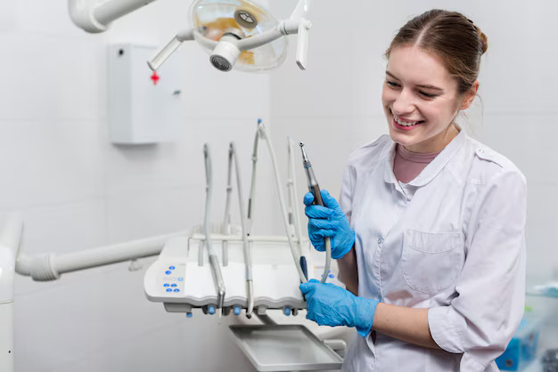 young woman dentist holding tools